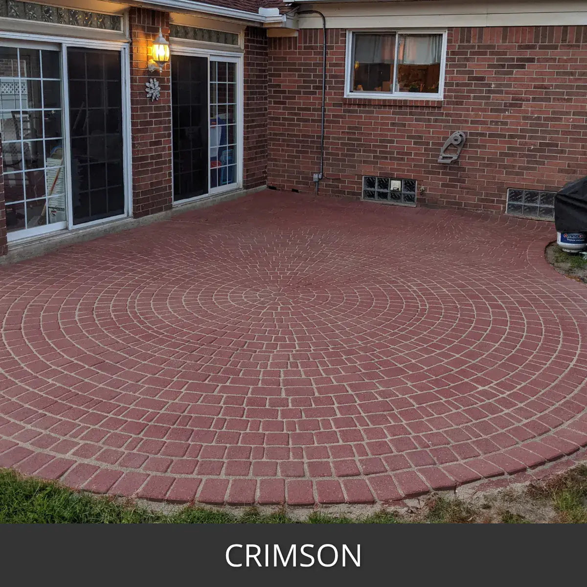 Stained paver patio in a circular pattern at a brick house, Portico™ Paver Stain in 709 Crimson