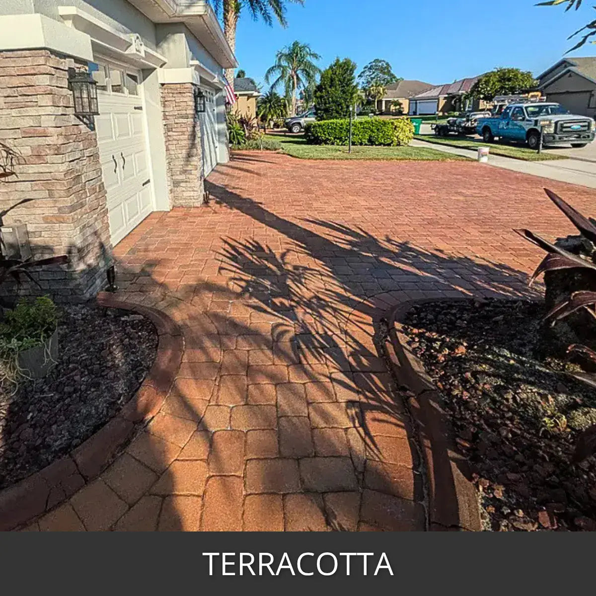 Stained paver driveway at a stucco house with palm shadows, Portico™ Paver Stain in 713 Terracotta