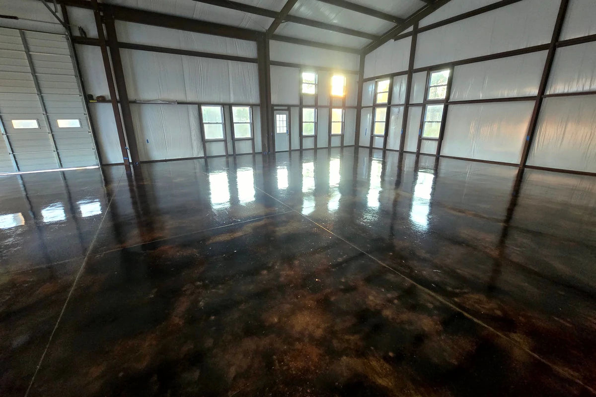 Acid stained concrete warehouse floor with a high gloss finish, EverStain™ in Coffee Brown sealed with EasySeal™ Gloss and finished with ProWax Polish™ Gloss