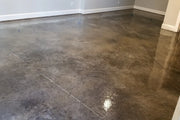 Dyed concrete basement floor with a high gloss finish, Vibrance™ in 332 Driftwood and 335 Stormy Gray sealed with AcquaSeal™ Gloss and finished with ProWax Polish™ Gloss