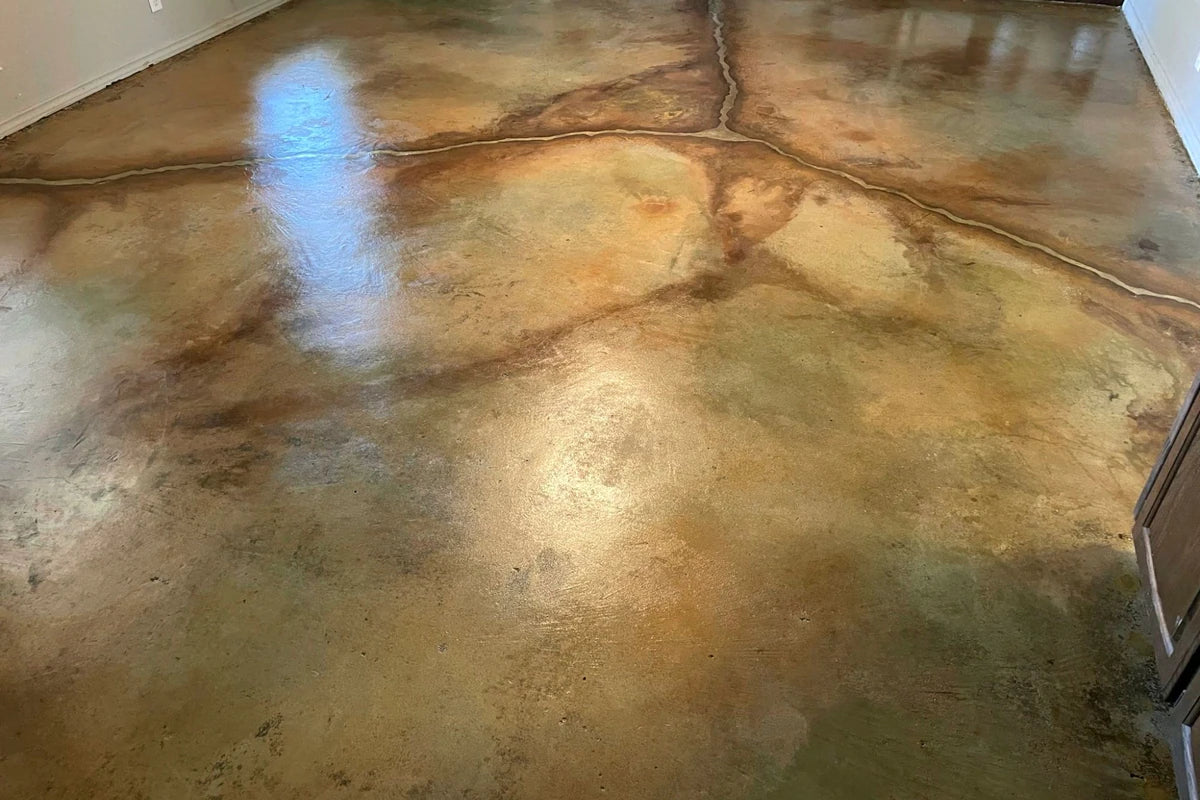 Multicolor acid stained concrete floor in an art studio, EverStain™ in Black, Coffee Brown, Desert Amber, Malayan Buff and Seagrass, sealed with AcquaSeal™ Satin and finished with ProWax Polish™ Satin