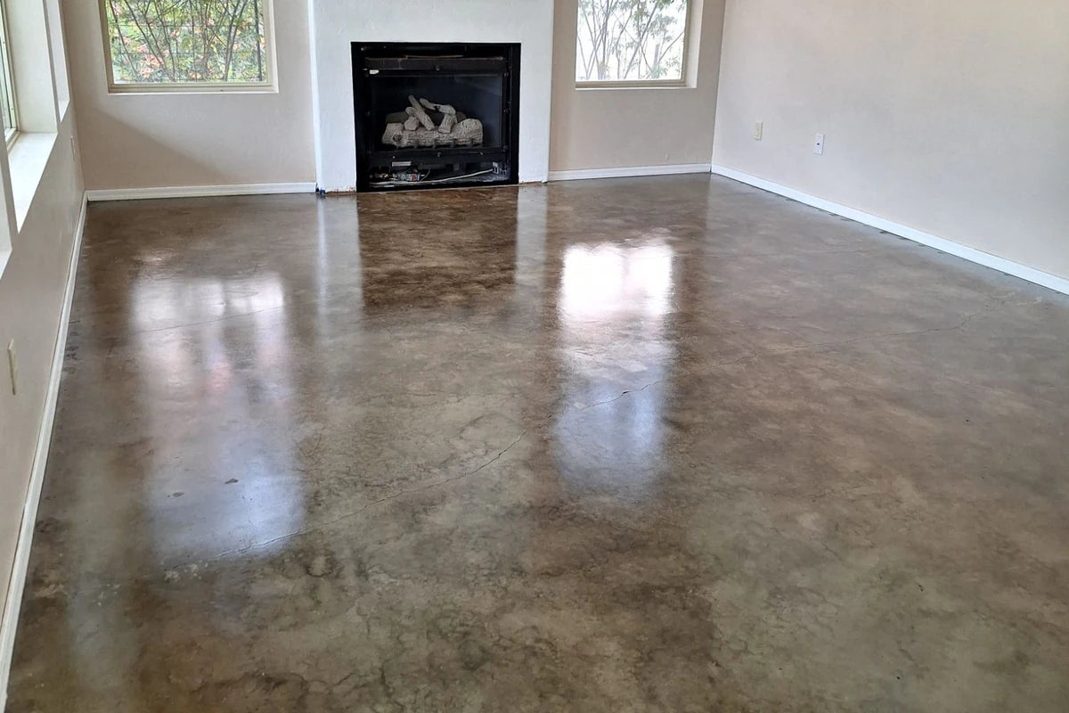 Stained concrete living room floor in front of a fireplace, ColorWave® in 603 Stone sealed with AcquaSeal™ Satin and finished with ProWax Polish™ Satin
