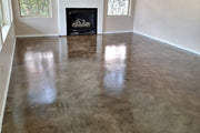Stained concrete living room floor in front of a fireplace, ColorWave® in 603 Stone sealed with AcquaSeal™ Satin and finished with ProWax Polish™ Satin