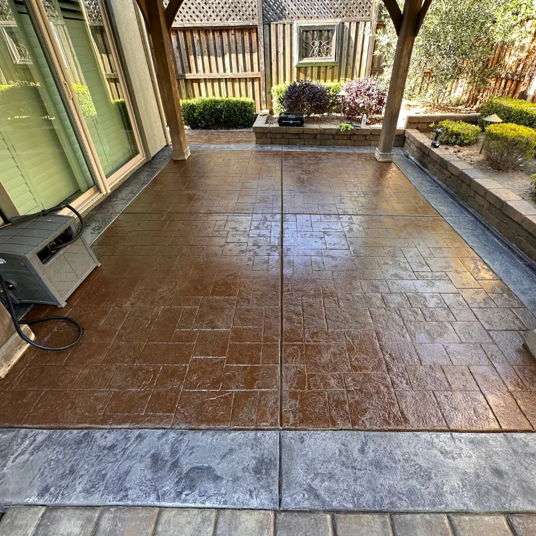 Outdoor patio with stone pavement and garden area