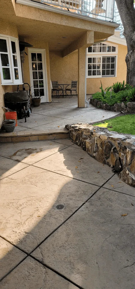 A before photo showing faded and colorless stamped concrete