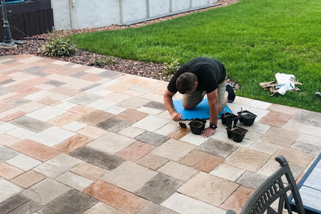 Sponging Auburn, Khaki, Terracotta, and Yukon Gold Antiquing stain onto an ashlar-pattern stamped concrete patio