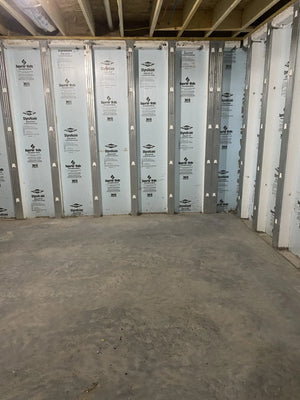 nfinished basement with exposed insulation and untreated concrete floor