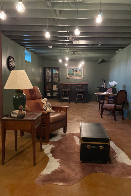 Basement whiskey bar with Malayan Buff acid-stained concrete floor