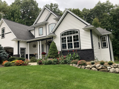 Full view of the house showcasing its finished black Portico stone facade transformation