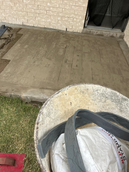 Concrete overlay stamped with a 6-inch boardwalk wood-plank-with-knots stamp mat