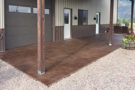 The same outdoor area post application of driftwood concrete stain, showcasing a broomed finish