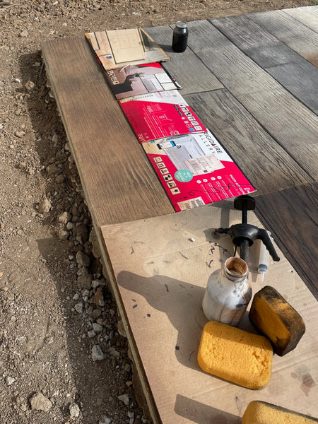 Sponging Coffee Brown Vibrance dye base coat onto wood-plank stamped concrete