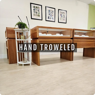 Wooden display cases with 'Hand Troweled' text in a room setting.