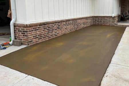 Freshly poured concrete patio integrally colored with Tobacco pigment before wood-plank stamping