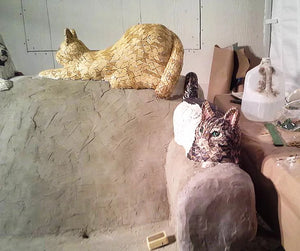 Concrete cats on concrete couch