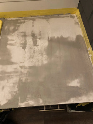 Ash gray smooth concrete overlay over laminate bathroom vanity countertop