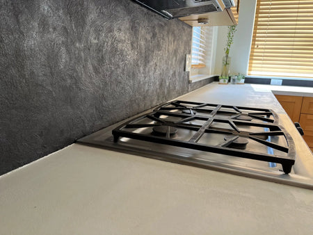Refinished Formica countertop with a pearl white concrete overlay and a tile backsplash with a titanium concrete overlay