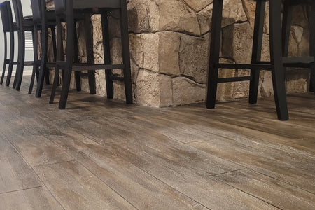 Interior wood-plank stamped concrete floor colored with Driftwood AcquaTint water-based tinted sealer