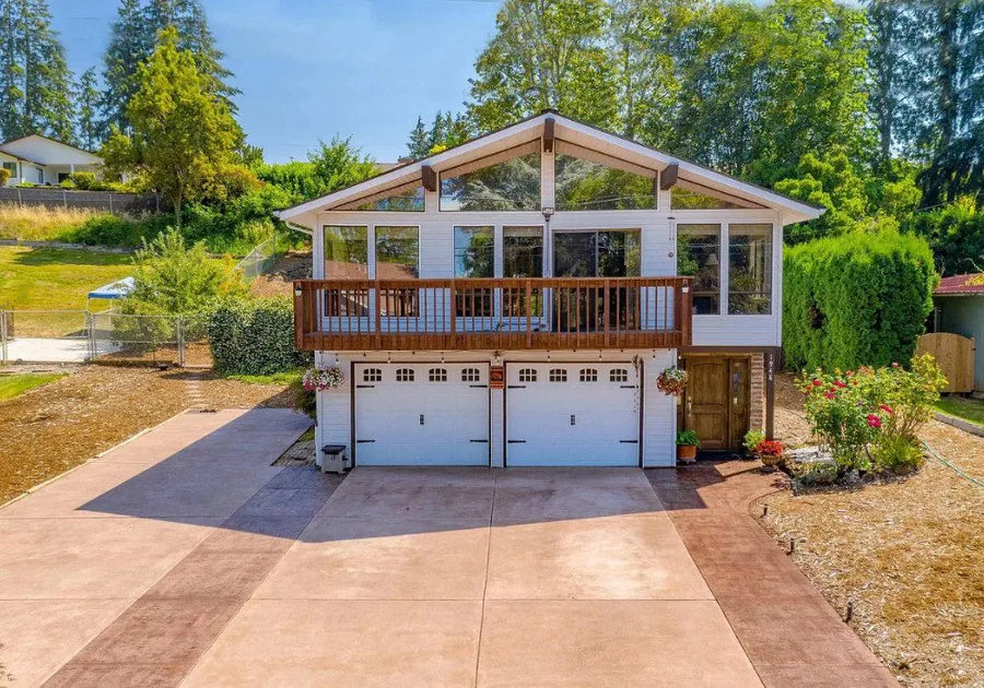 The driveway and porch boast the rich tones of Aztec Brown and Sunset Tan, creating a warm welcome