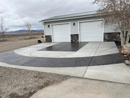 Image of a driveway stained with black EasyTint tinted sealer, featuring basketball court lines and accents