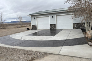 Decorative concrete driveway with sweeping black stained sections created using Black EasyTint and EasySeal Gloss