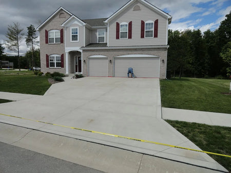 Before photo of a plain concrete driveway