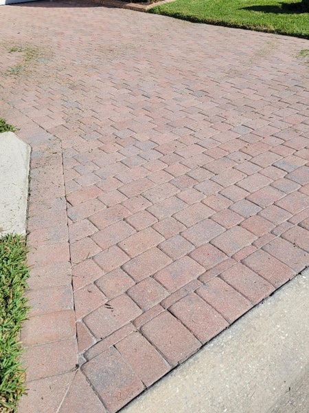 Faded concrete paver driveway with worn color before a Crimson stain refresh