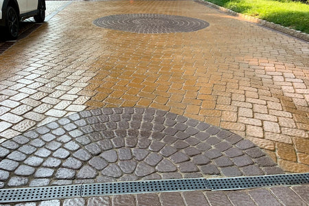 Stained paver-style concrete driveway with Goldenrod main color and Aztec Brown circular accents after refinishing