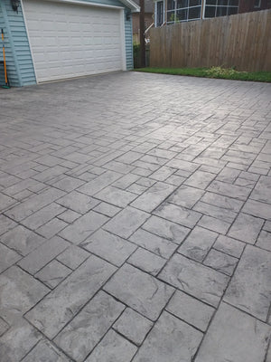 Ashlar slate stamped concrete driveway after Light Charcoal Antiquing application