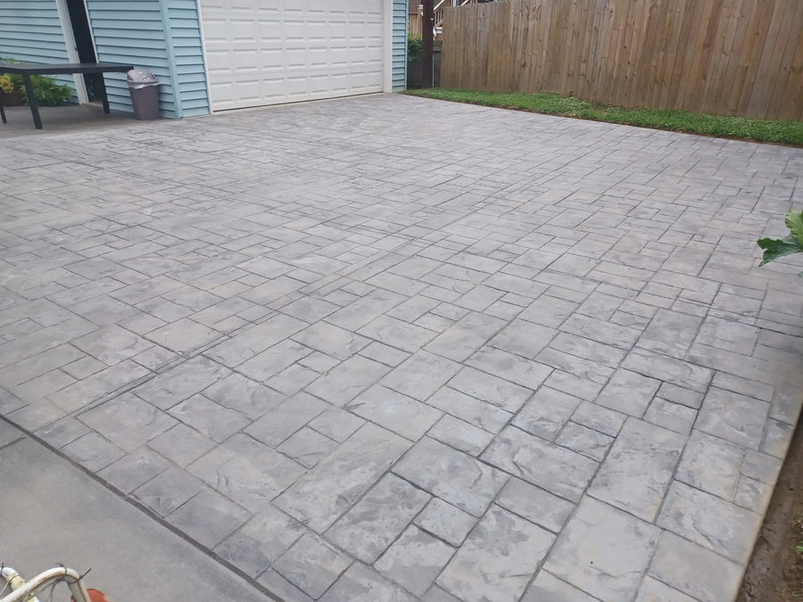 Cleaned ashlar slate stamped concrete driveway with visible splotchy clearcoat