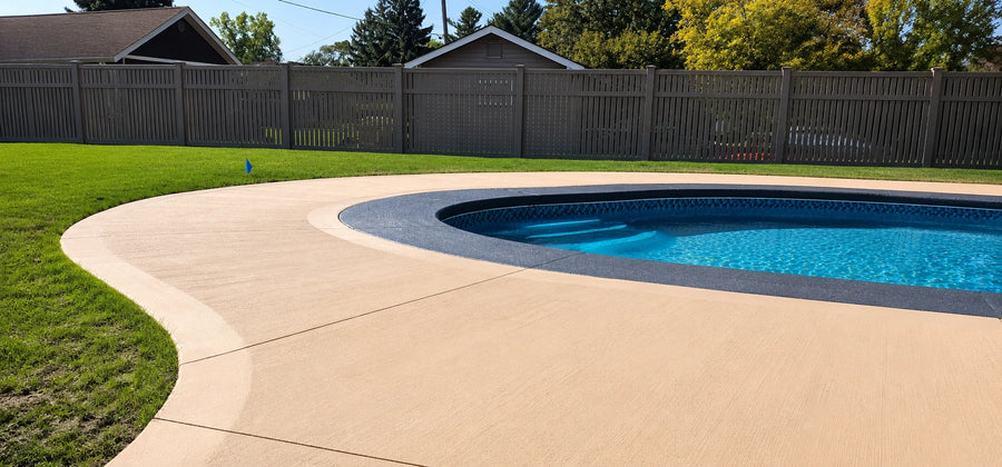 EasyTint tinted solvent-based acrylic concrete sealer applied to a broomed exterior pool deck, delivering one-step color and seal in a single application