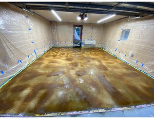 Applying the acid-stain to the garage floor