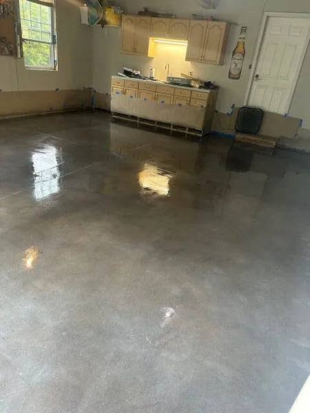 Finished garage floor with a sleek, polished look using charcoal, stormy gray, and white Vibrance dye