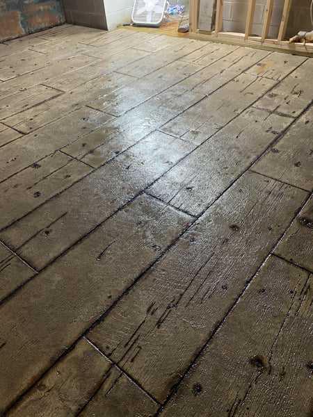 Wood-plank stamped concrete porch colored with Gray AcquaTint for a weathered driftwood-gray wood look