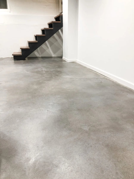 Sealer being applied to dyed concrete surface to protect the color