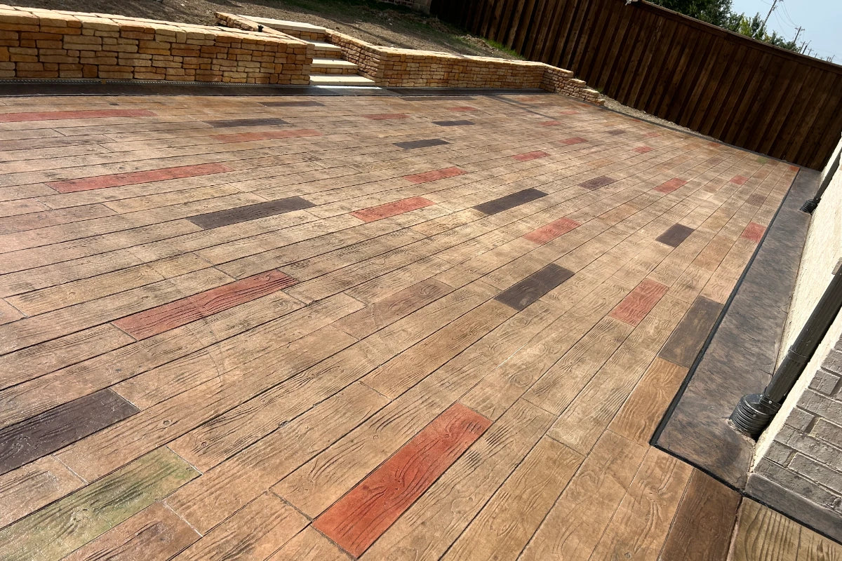 Wood-plank stamped concrete patio finished with multicolor Crimson, Cumin, Aztec Brown, and Fern Green Antiquing accent planks