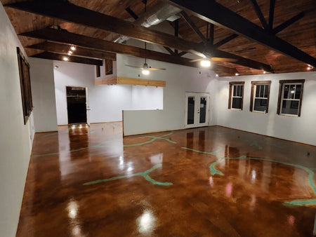 acid stained concrete floor with azure blue through rich cola and black tones