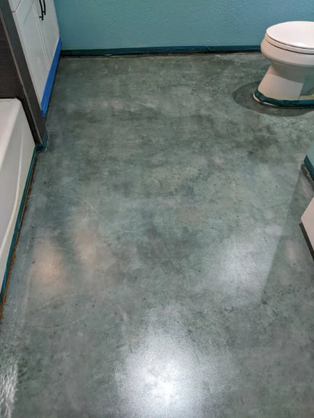 Azure blue acid-stained concrete bathroom floor