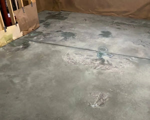 Concrete floor showing the chalky appearance of Azure Blue acid stain during the drying process