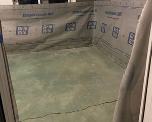 Sunroom floor midway through transformation, showing the application of Azure Blue acid stain