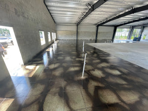 Photo of a finished concrete floor, with a glossy and polished surface, showcasing the final outcome of the acid staining process