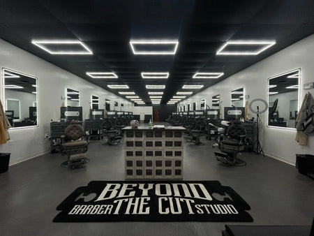 Finished, modern industrial-style barbershop floor, featuring gray and black tones, with freshly painted ceiling, creating a sleek and masculine ambiance