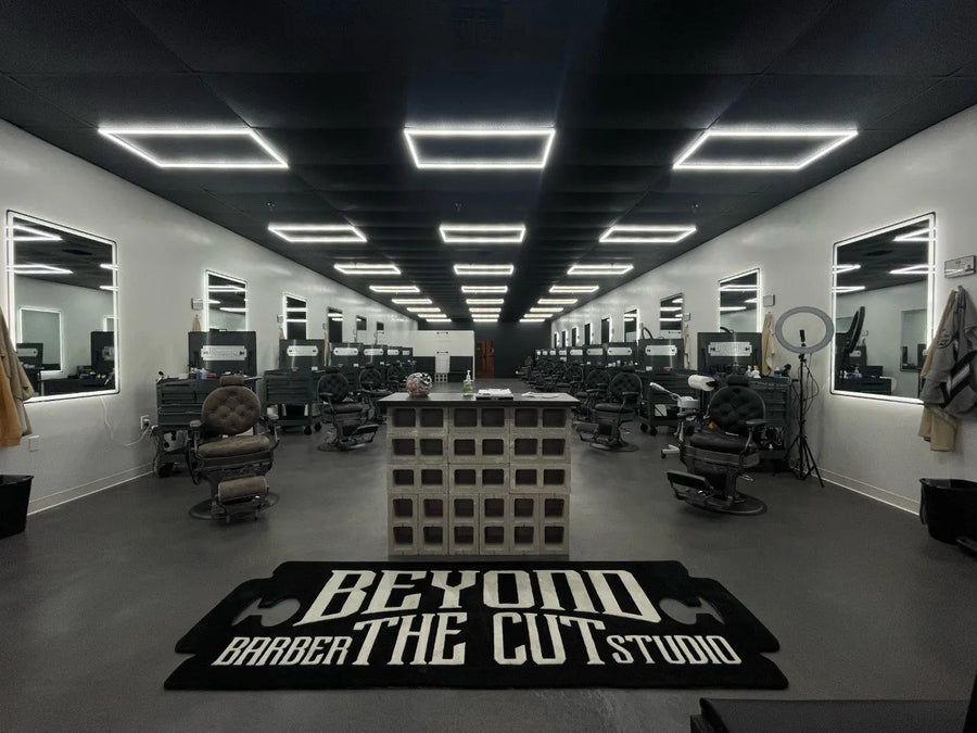 Finished, modern industrial-style barbershop floor, featuring gray and black tones, with freshly painted ceiling, creating a sleek and masculine ambiance