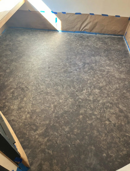 Concrete floor showing the depth and variation in color after a second coat of Charcoal Vibrance Dye applied with a sponge