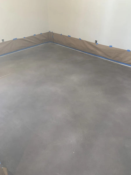 Concrete floor after additional spraying, with dominant white hues blending into charcoal Vibrance Dye