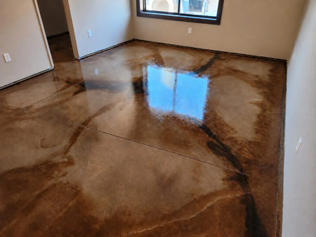 Blackish Desert Amber and Malayan Buff acid stained concrete floor with dark marbled veining