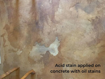 Acid-stained floor with unstained spots from oil spills