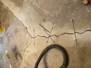 An image showing the raw concrete floor with visible stitches