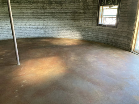 Image of the concrete floor after application and neutralization of Malayan Buff stain, now clean and dry