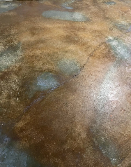 Image of the same room after renovation, showcasing the new acid-stained concrete floor in Malayan Buff and Seagrass